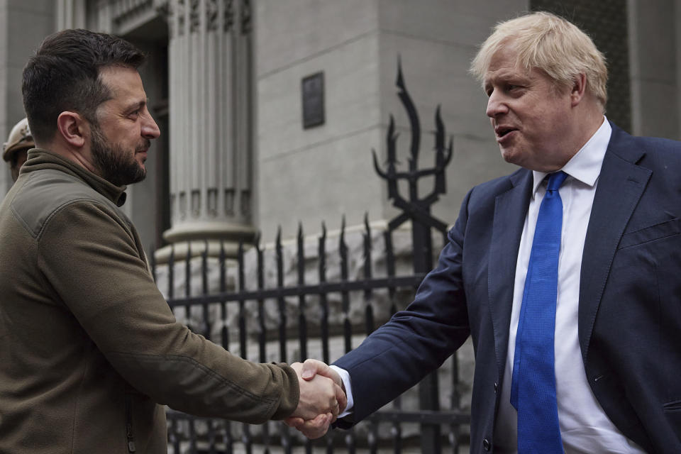 FILE - In this image provided by the Ukrainian Presidential Press Office, Ukrainian President Volodymyr Zelenskyy, left, and Britain's Prime Minister Boris Johnson, shake hands during their walk in downtown Kyiv, Ukraine, Saturday, April 9, 2022. When British Prime Minister Boris Johnson survived a no-confidence vote this week, at least one other world leader shared his relief. Ukrainian President Volodymyr Zelenskyy said it was “great news” that “we have not lost a very important ally.” (Ukrainian Presidential Press Office via AP, File)