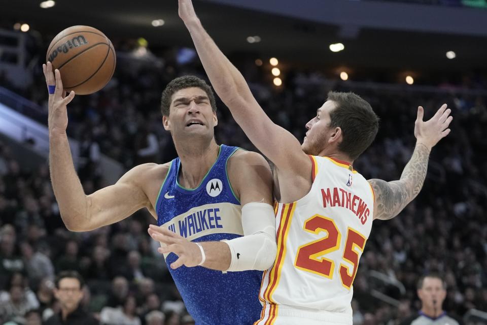 Atlanta Hawks' Garrison Mathews fouls Milwaukee Bucks' Brook Lopez during the second half of an NBA basketball game Saturday, Dec. 2, 2023, in Milwaukee. The Bucks won 132-121. (AP Photo/Morry Gash)