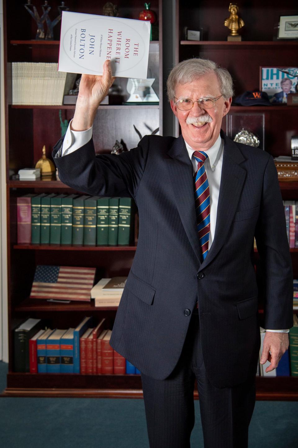 Former national security adviser John Bolton, at a USA TODAY interview about his White House memoir, mimics the controversial photograph of President Trump holding a Bible aloft in front of St. John's Church after protesters had been cleared from Lafayette Park.