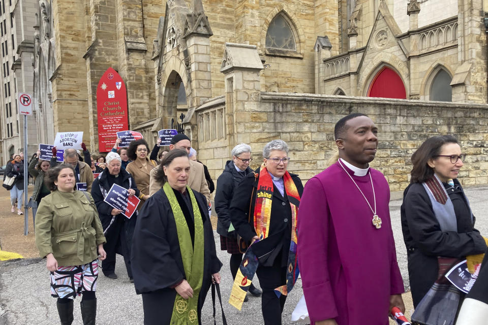 Clergy who filed suit seeking to overturn Missouri’s abortion law and other opponents of the law hold a March through downtown St. Louis on Thursday, Jan. 19, 2023. The suit says Missouri legislators invoked their religious beliefs while drafting the law in violation of the Missouri Constitution. (AP Photo/Jim Salter)