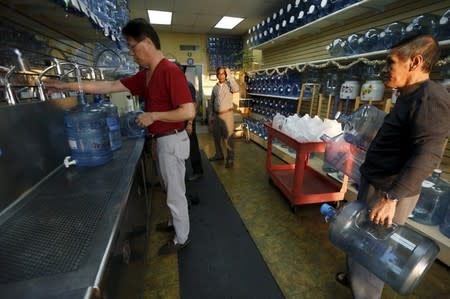 People refill bottles at a water store in Temple City, California, United States March 4, 2016. REUTERS/Mario Anzuoni