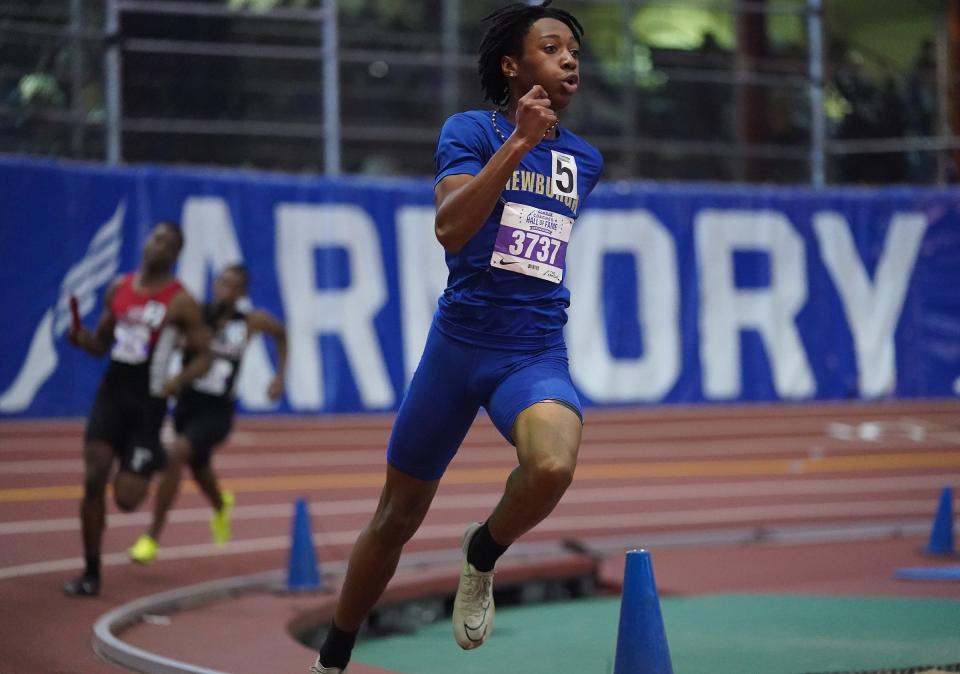 Newburgh senior David Pinnock carries the baton in the boys large-school 4x400 relay during The JAMBAR Coaches Hall of Fame Invitational at Armory Track & Field Center in New York on Saturday, Dec 16, 2023. Newburgh won the event.