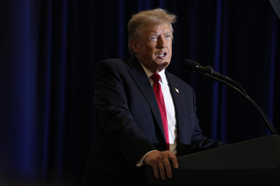 FILE - Former President Donald Trump speaks during a commit to caucus rally, Wednesday, Dec. 13, 2023, in Coralville, Iowa. Trump says he is eager to debate President Joe Biden, even if the debates are sponsored by the nonpartisan Commission on Presidential Debates. And he says he is open to debating a single Republican rival if a serious challenger emerges after the New Hampshire primary. (AP Photo/Charlie Neibergall, File)