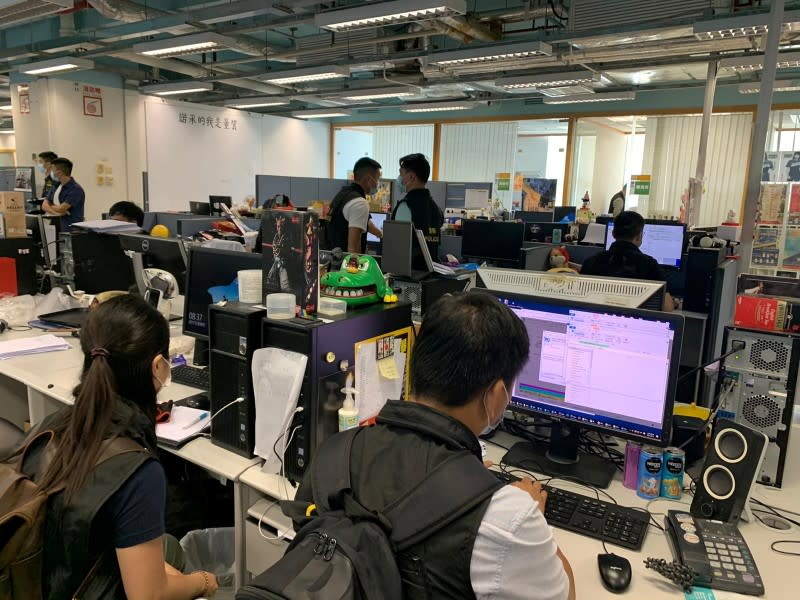 Police officers at the headquarters of Apple Daily in Hong Kong