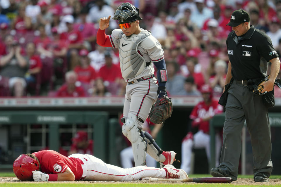 Home plate umpire Tripp Gibson, right, and Atlanta Braves catcher William Contreras, center right, react after Cincinnati Reds' Nick Senzel is hit by a pitch during the fifth inning of the team's baseball game Saturday, July 2, 2022, in Cincinnati. (AP Photo/Jeff Dean)