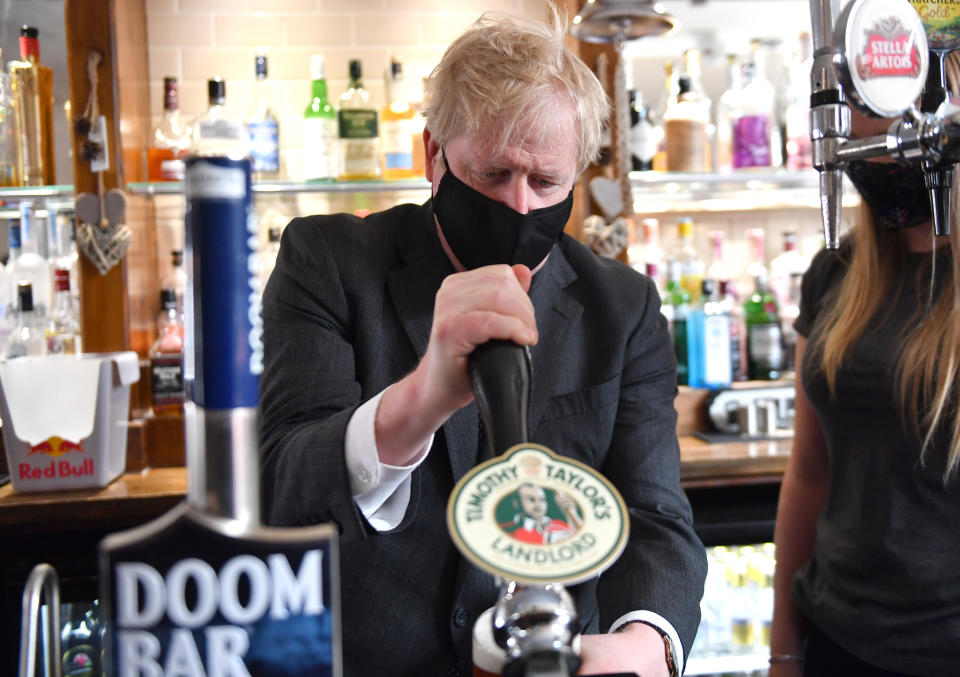 <p>Prime Minister Boris Johnson pours a pint in the beer garden during a visit to The Mount Taven public house and restaurant in Wolverhampton, West Midlands, on the local election campaign trail. Picture date: Monday April 19, 2021.</p>
