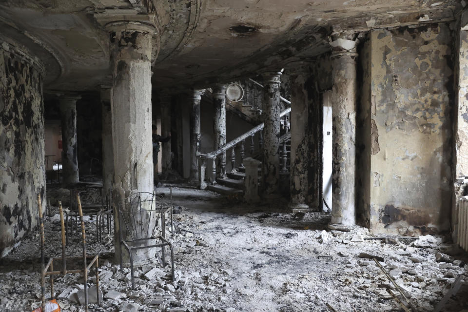 FILE - Debris covers the inside of the Donetsk Academic Regional Drama Theatre following a March 16, 2022, bombing in Mariupol, Ukraine, in an area now controlled by Russian forces, Monday, April 4, 2022. The bombing of the theater that was used as a shelter stands out as the single deadliest known attack against civilians to date in the war. (AP Photo/Alexei Alexandrov, File)