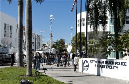 Media gather outside Miami Beach police station in Miami Beach, Florida January 23, 2014. REUTERS/Gary I. Rothstein