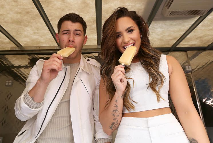 HOLLYWOOD, CA - SEPTEMBER 17: Nick Jonas and Demi Lovato hand out sweet treats and tickets to Demi Lovato's sold out show for Marriott Rewards Members in Los Angeles next week at TCL Chinese Theatre on September 17, 2016 in Hollywood, California. (Photo by Jesse Grant/Getty Images for Universal Music Group)