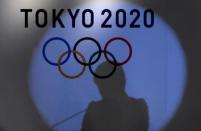 A shadow of of Tokyo governor Yuriko Koike is seen on the logo of Tokyo 2020 Olympic games during the Olympic and Paralympic flag-raising ceremony at Tokyo Metropolitan Government Building in Tokyo, Japan, September 21, 2016. REUTERS/Toru Hanai