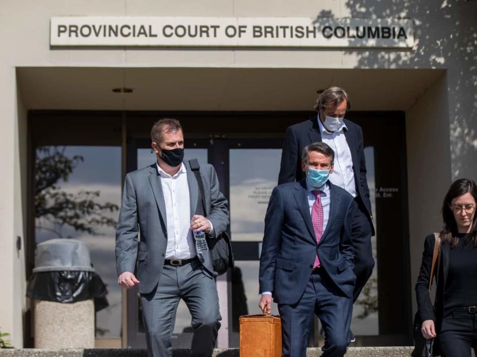 Former Vancouver Whitecaps and Team Canada coach Bob Birarda, left, is pictured leaving court in North Vancouver after day one of his sentencing hearing. Birarda has pleaded guilty to four sex-related charges involving four players he used to coach. (Ben Nelms/CBC - image credit)