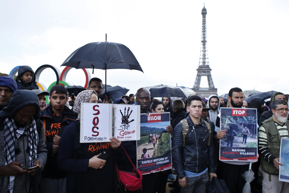 <p>People hold placards during a rally to protest the situation of Rohingya refugees fleeing Myanmar’s Arakan State, in Paris, Saturday, Sept. 16, 2017. (Photo: Thibault Camus/AP) </p>