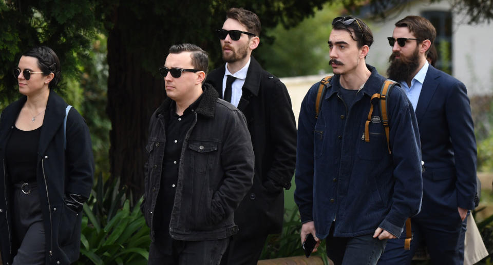 Friends of Lucas Fowler are shown arriving at his Sydney funeral on Friday.