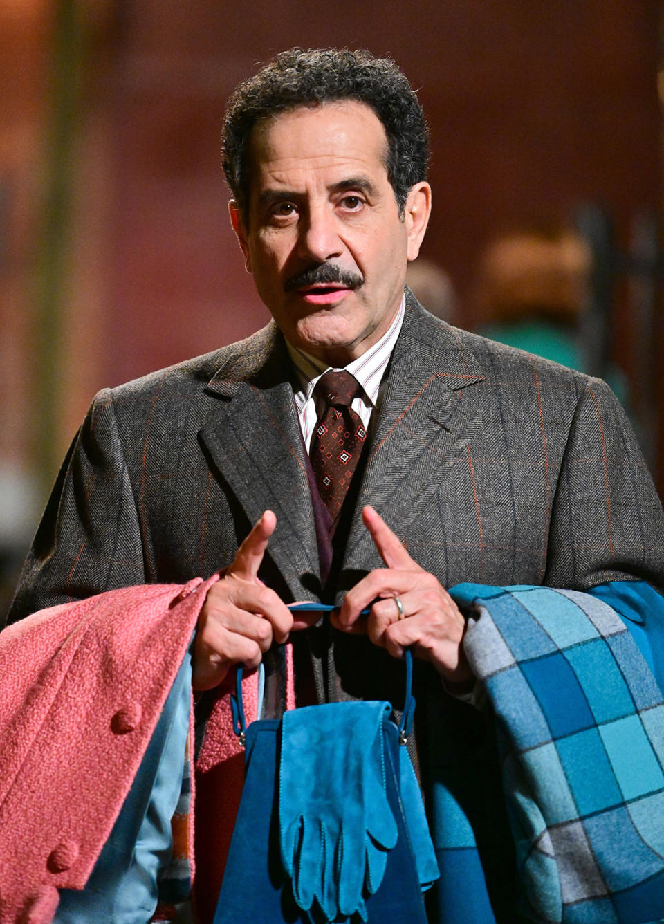 <p>Tony Shalhoub, who plays Brosnahan's father in the series, carries some coats and accessories while filming on May 27. </p>