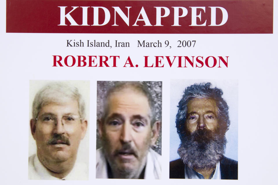 FILE - In this March 6, 2012, file photo, an FBI poster showing a composite image of former FBI agent Robert Levinson, right, of how he would look like now after five years in captivity, and an image, center, taken from the video, released by his kidnappers, and a picture before he was kidnapped, left, displayed during a news conference in Washington. Iran is acknowledging for the first time it has an open case before its Revolutionary Court over the 2007 disappearance of a former FBI agent on an unauthorized CIA mission to the country. In a filing to the United Nations, Iran said the case over Robert Levinson was "on going," without elaborating. The Associated Press obtained the text of the filing Saturday, Nov. 9, 2019. (AP Photo/Manuel Balce Ceneta, File)