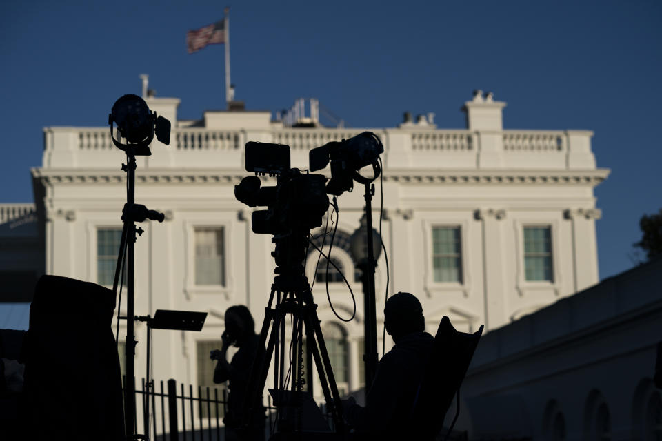 FILE - Journalists gather outside the White House in Washington on Nov. 4, 2020. President Joe Biden’s $1.85 trillion social spending bill includes a provision that, if it becomes law, would mark the first time the federal government has offered targeted support to local news organizations. The help comes in the form of a payroll tax credit for companies that employ eligible local journalists. (AP Photo/Evan Vucci, File)