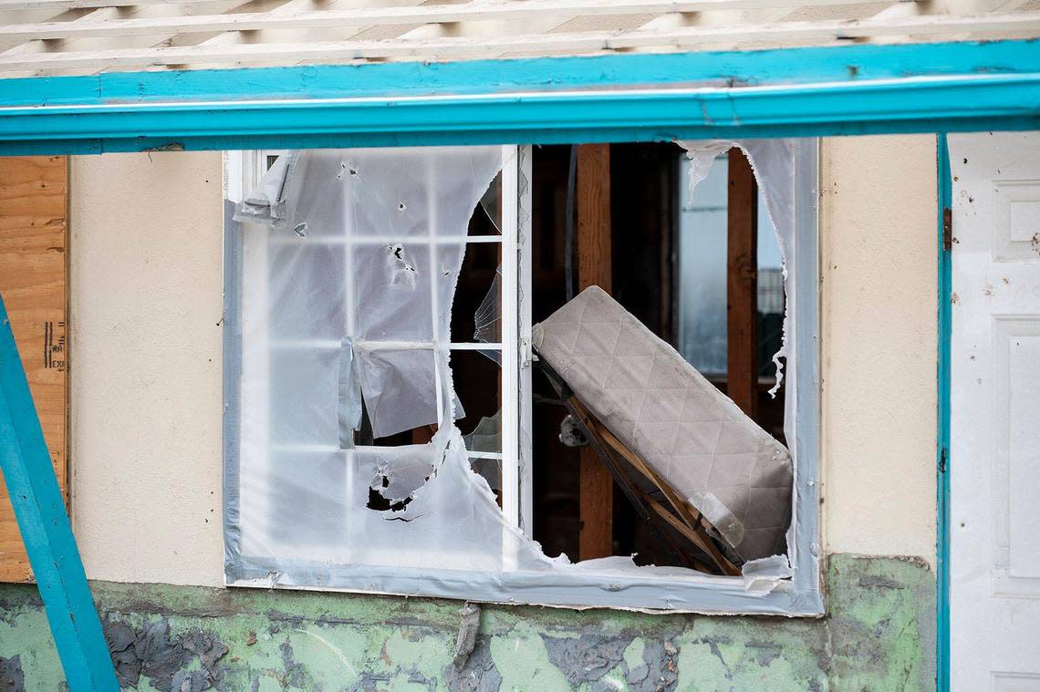 Part of a bed is visible through a window in a section of building still standing, as the Siesta Motel, located at 1347 W. 16th Street, is demolished in Merced, Calif., on Thursday, Aug. 4, 2022.