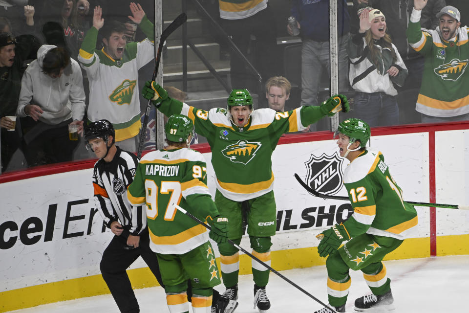 Minnesota Wild center Marco Rossi, center, celebrates with left wings Kirill Kaprizov (97) and Matt Boldy (12) after scoring a goal against the New York Rangers during the third period of an NHL hockey game Saturday, Nov. 4, 2023, in St. Paul, Minn. (AP Photo/Craig Lassig)