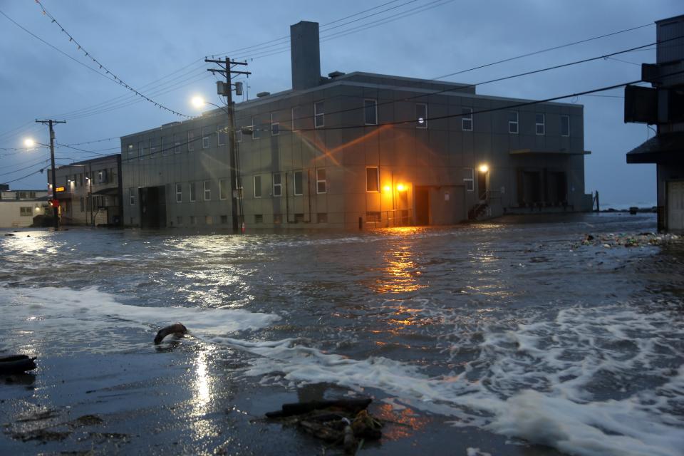 Water rushes down Front Street, just a half block from the Bering Sea, in Nome, Alaska, on Saturday, Sept. 17, 2022. (Peggy Fagerstrom / AP)