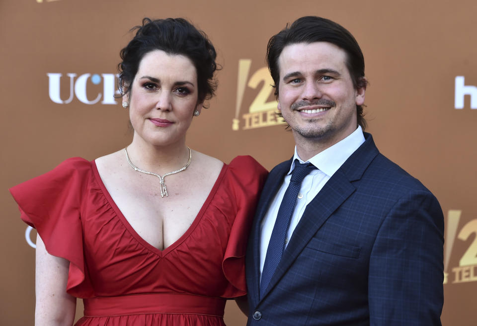 Cast member Melanie Lynskey, left, arrives with her husband and fellow cast member, Jason Ritter, at the Los Angeles premiere of "Candy," on Monday, May 9, 2022, at El Capitan Theatre. (Photo by Jordan Strauss/Invision/AP)