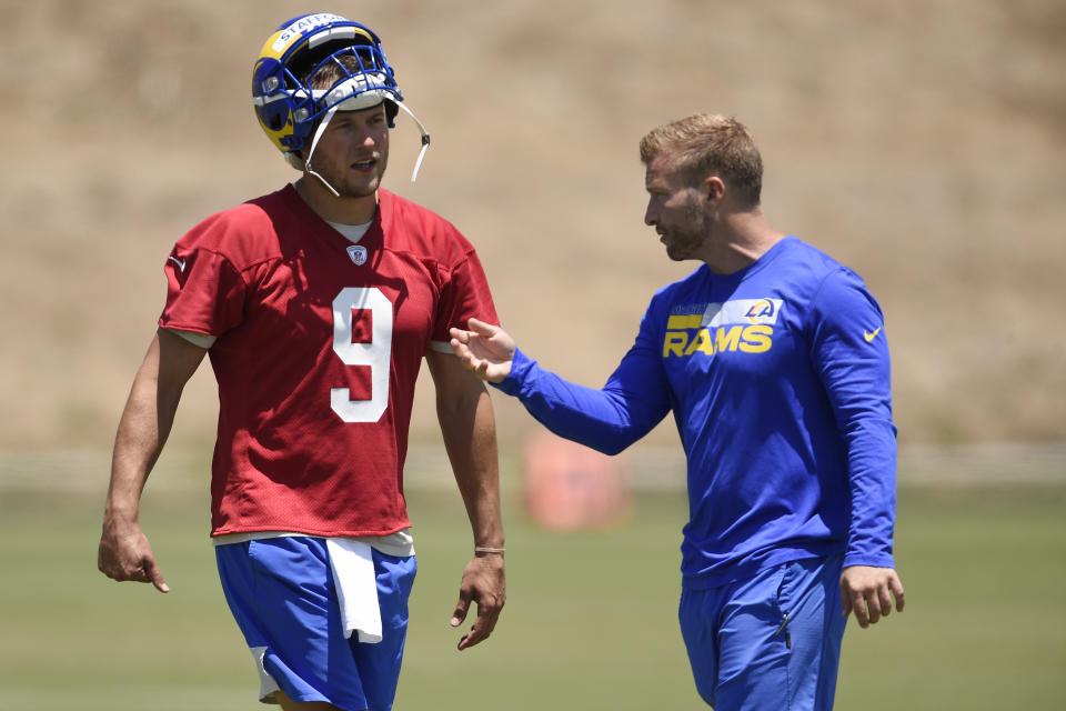 Los Angeles Rams' Matthew Stafford talks with head coach Sean McVay after an NFL football practice in Thousand Oaks, Calif., Thursday, May 27, 2021. (AP Photo/Kelvin Kuo)