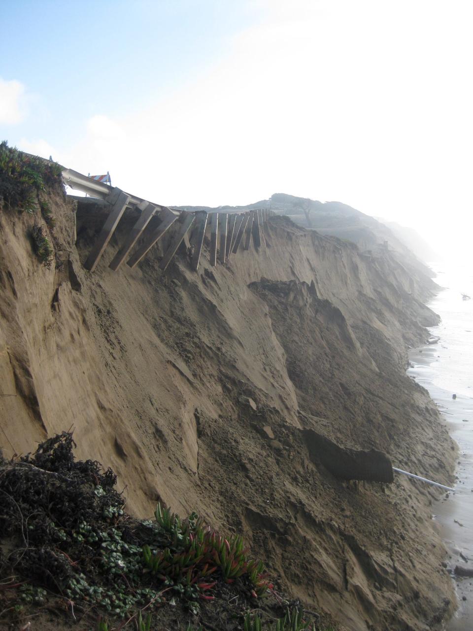 Bluff erosion during the 2009–10 El Niño undermined the Great Highway guardrail at the southern end of Ocean Beach, San Francisco, California on  January 20, 2010. The shoreline eroded, on average, 55 meters that winter, leading to lane closures on the highway and an emergency $5-million revetment along the base of this bluff.