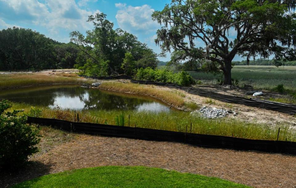 A retention pond now separates the backyard of Bobby and Duchess Raehn’s Jonesville Road home to a bench with kayaks under a live oak tree on a peninsula as pictured on May 9, 2023 on Hilton Head Island. The Raehn’s had received written confirmation from the original developer that access to the water would remain after the residential development is completed.