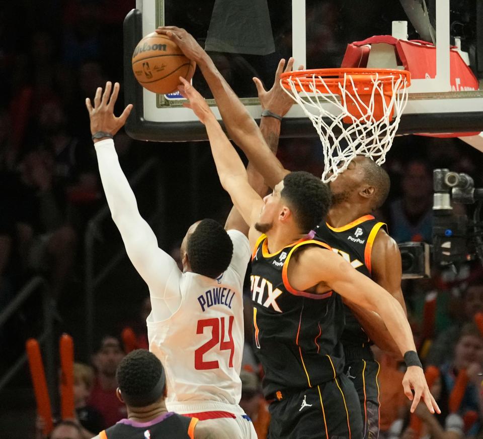 Phoenix Suns guard Devin Booker (1) and forward Kevin Durant (35) block a shot by Los Angeles Clippers guard Norman Powell (24) during Game 1 of their first-round playoff series at Footprint Center in Phoenix on April 16, 2023.