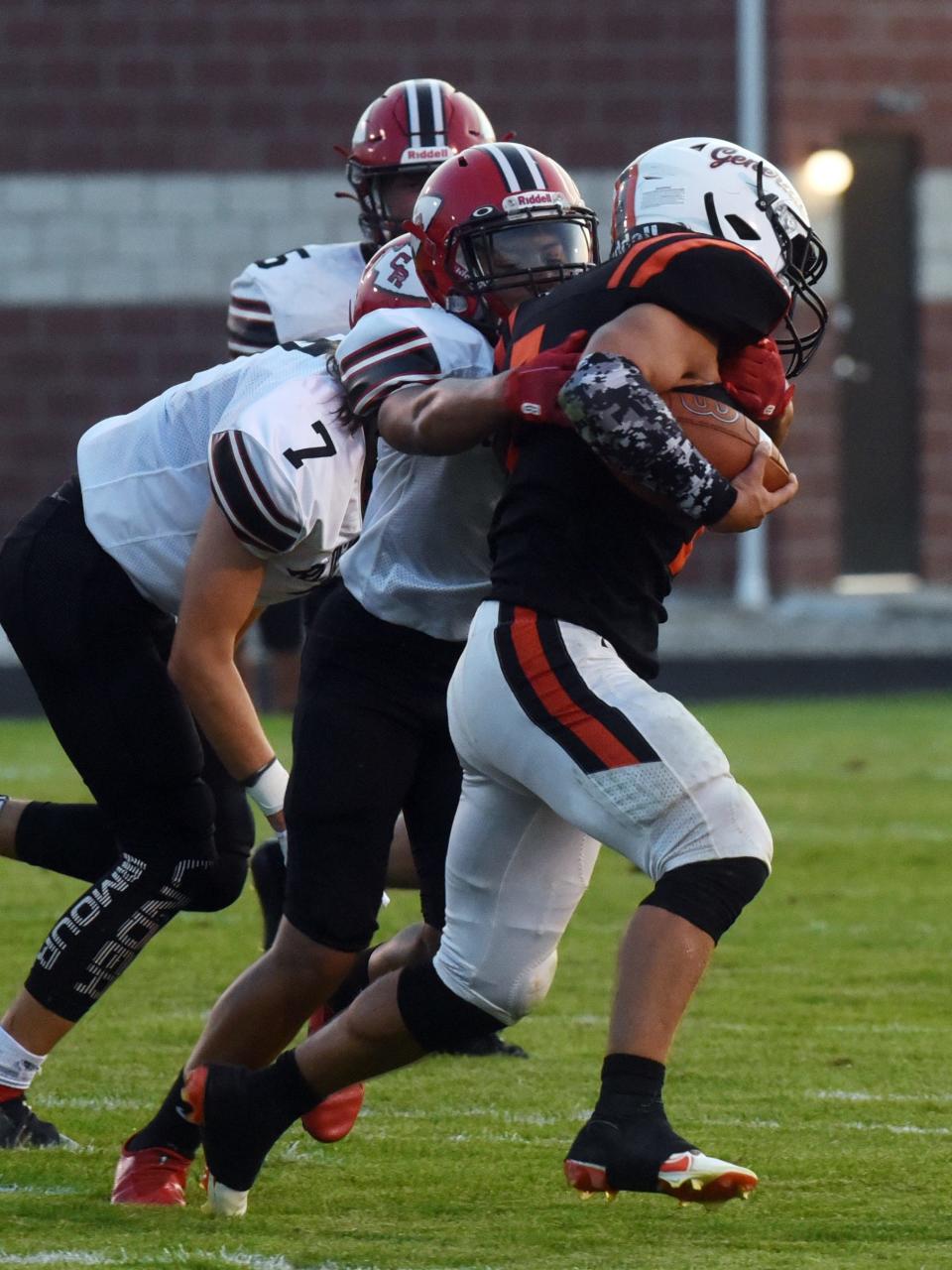 Ridgewood's Xavier Lamneck is tackled by a Coshocton defender. Ridgewood won, 51-0. 