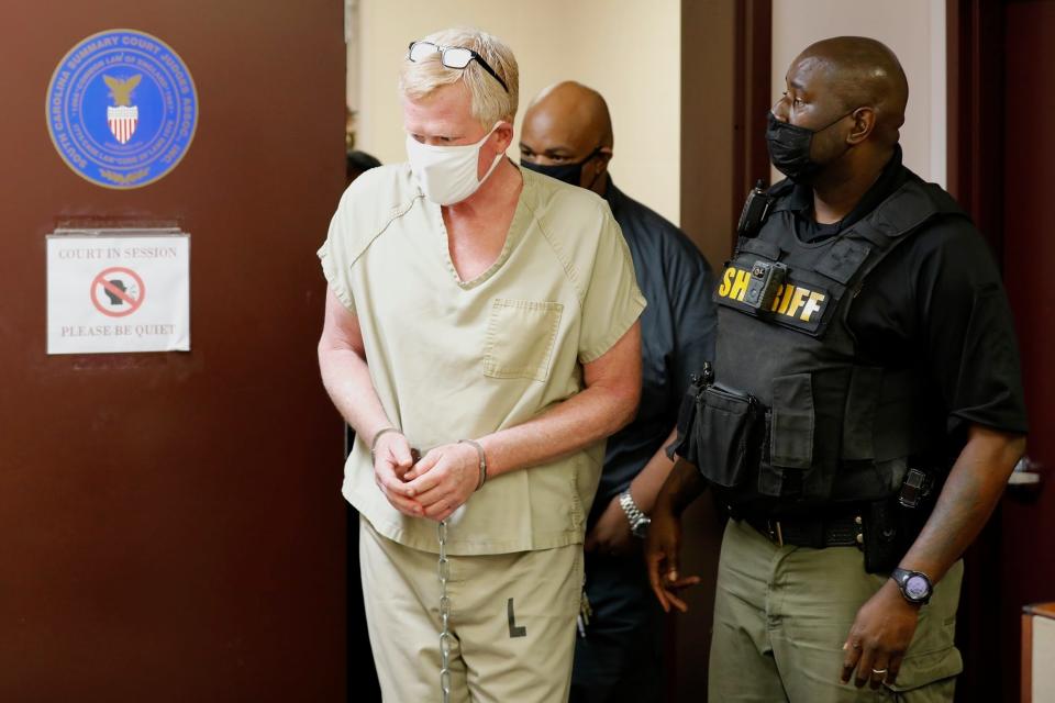 Disgraced South Carolina attorney Alex Murdaugh, left, walks into court for his bond hearing on Sept. 16, 2021, in Varnville, S.C. Murdaugh was charged Thursday, July 14, 2022, with murder in connection with the mysterious 2021 deaths of his wife and son.