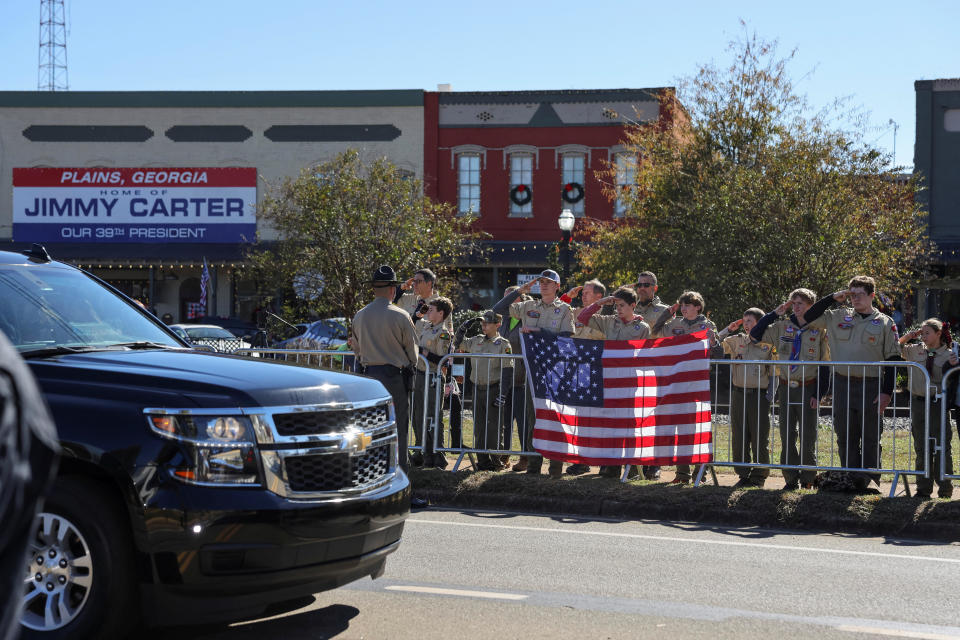 Boy Scouts salute as the funeral procession carrying the casket of former U.S. first lady Rosalynn Carter passes through downtown Plains, Georgia. / Credit: Elijah Nouvelage/REUTERS