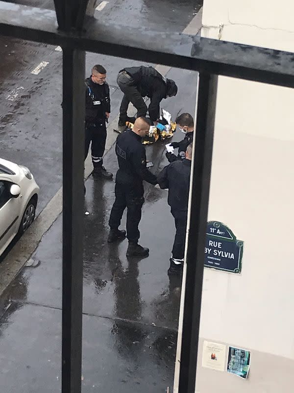 Emergency responders are pictured following a stabbing near the former offices of the Charlie Hebdo satirical magazine in Paris