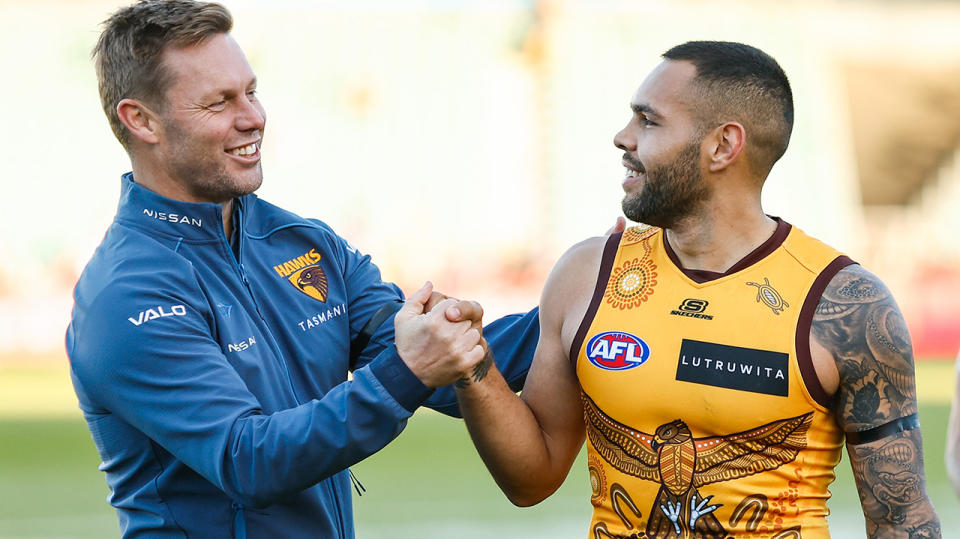 Hawthorn coach Sam Mitchell shakes hands with Jarman Impey.