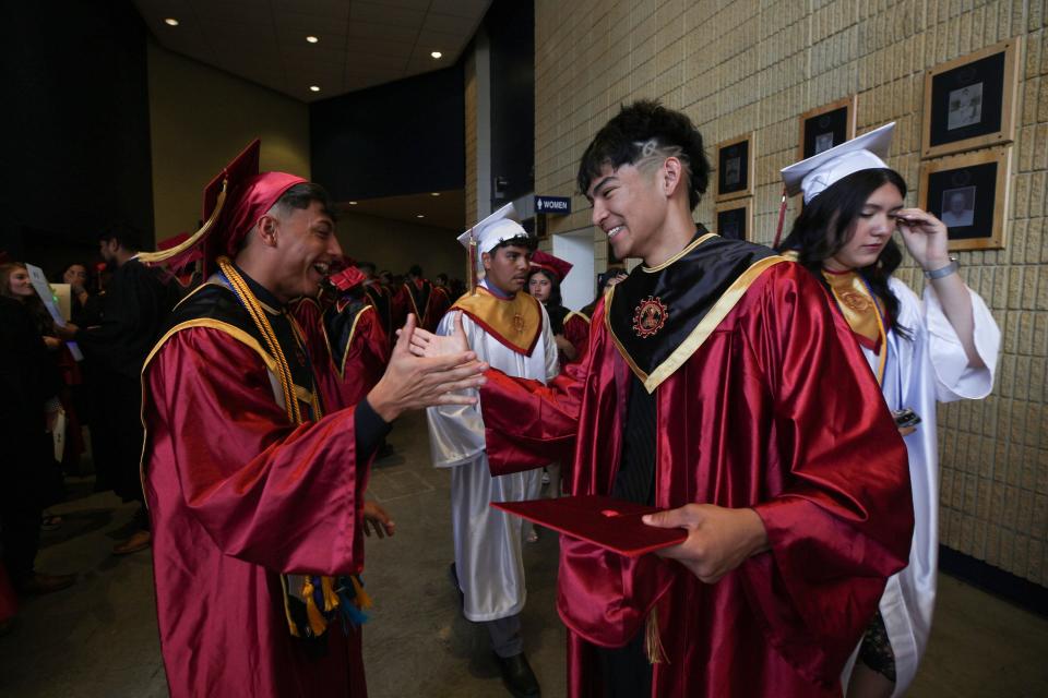 El Dorado High School graduates, from left, Dylan Fish and Devin Rubio greet each other as they prepare to begin commencement ceremonies on May 31, 2024, at the Don Haskins Center in El Paso, Texas. 533 students received their High School Diplomas.