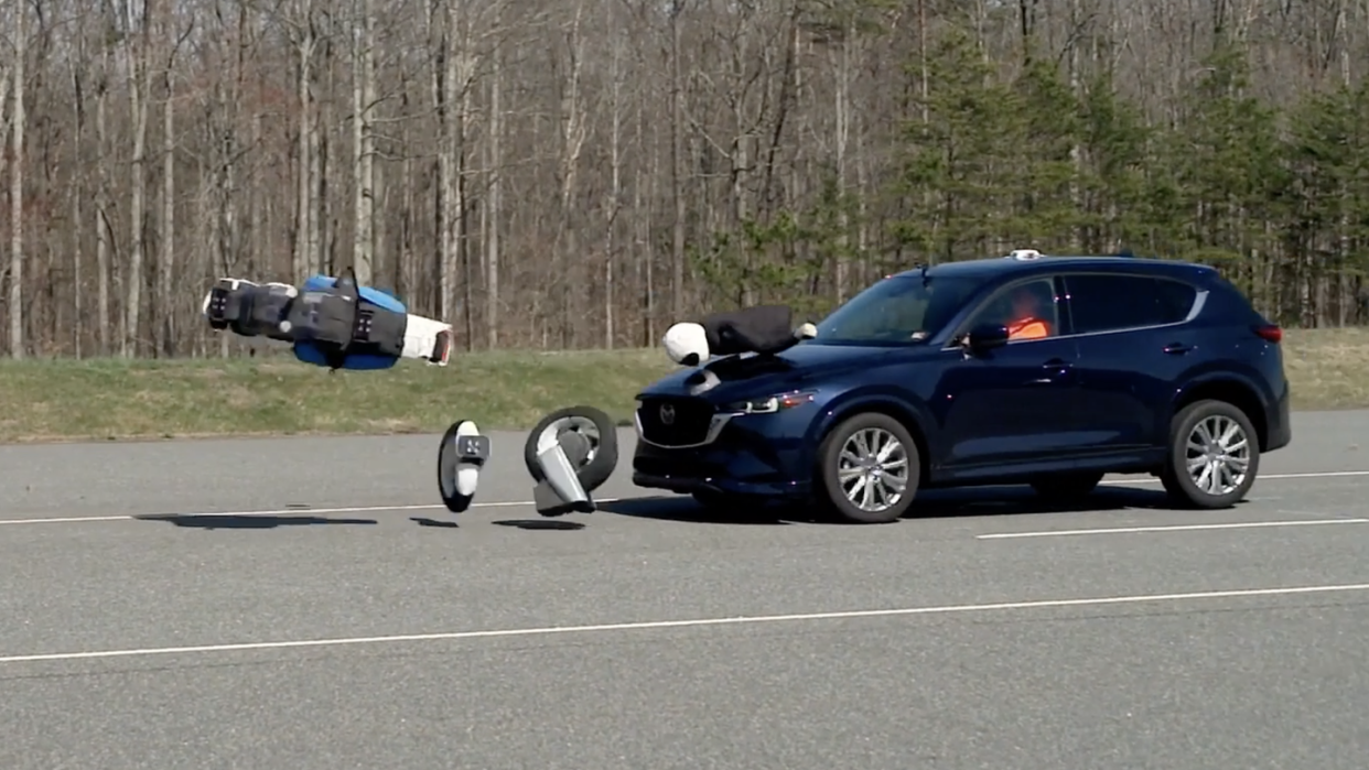 mazda crossover hits motorcycle crash test dummy in test