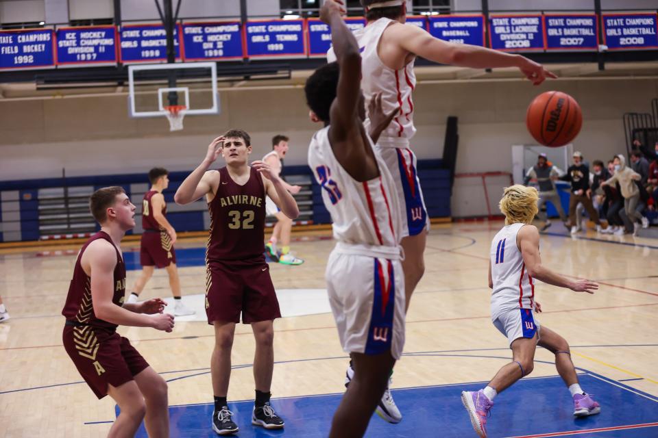 Alvirne's Brendan Graham (32) reacts after Winnacunnet's Josh Schaake hit a buzzer-beating, game-winning 3-pointer on Friday.