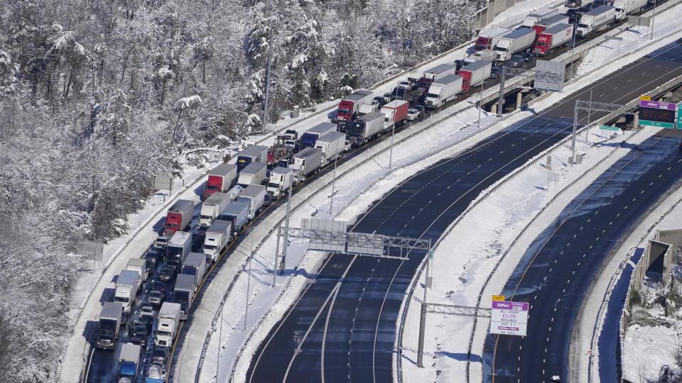 Cars and trucks are stranded on sections of Interstate 95 Tuesday Jan. 4, 2022, near Quantico, Va. Close to 48 miles of the Interstate was closed due to ice and snow. (AP Photo/Steve Helber)