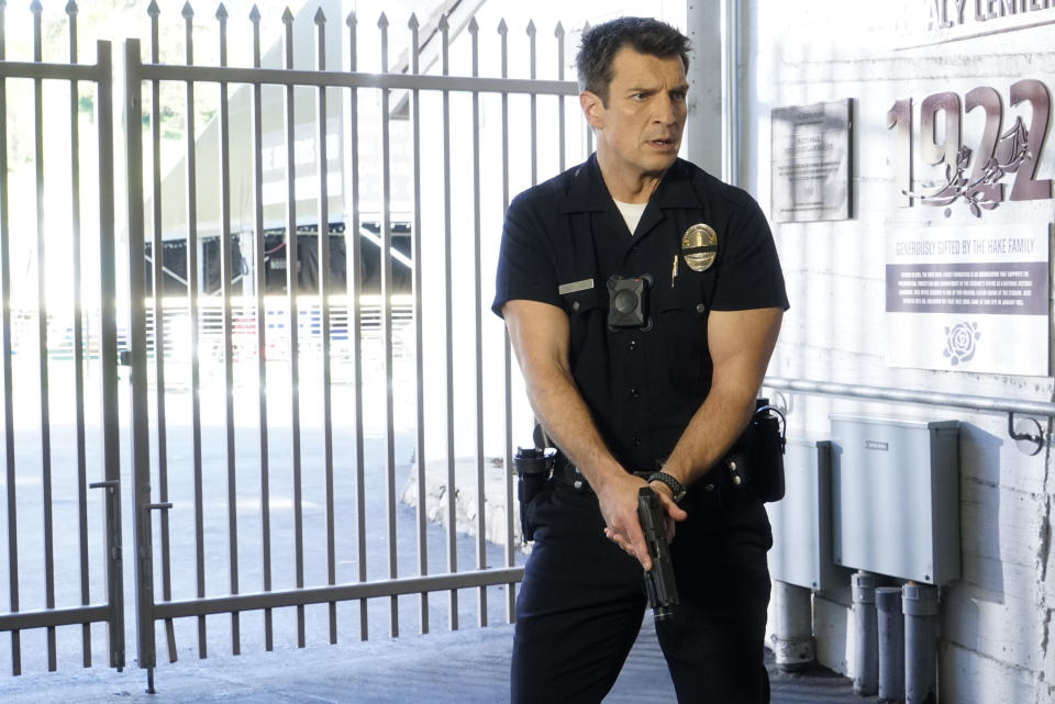 This image released by ABC shows Nathan Fillion in a scene from "The Rookie." The May 25 killing of George Floyd at the hands of Minneapolis police has set off protests worldwide and transmitted images of law enforcement that long remained far outside the narratives of crime stories. (Kelsey McNeal/ABC via AP)