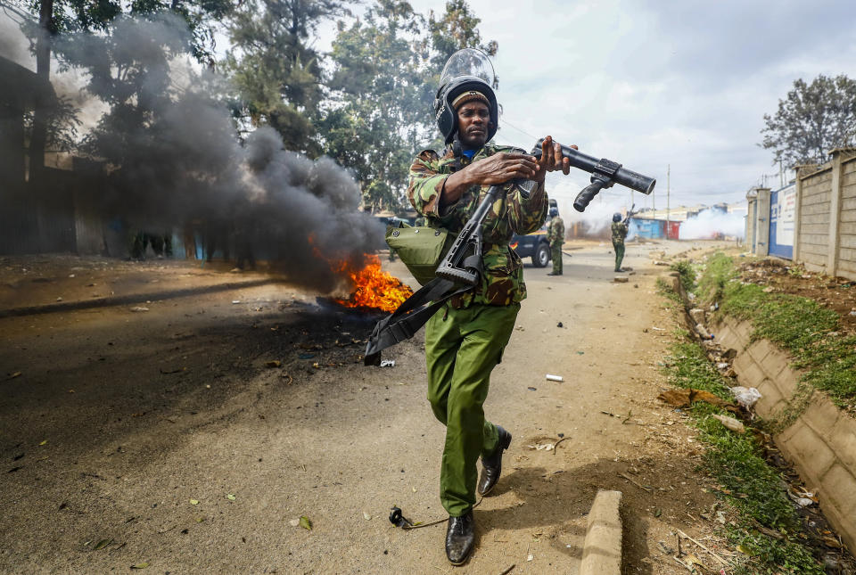 FILE - A riot policeman reloads a teargas grenade launcher during clashes with protesters in the Kibera area of Nairobi, Kenya on July 19, 2023. The United States is praising Kenya's interest in leading a multinational force in Haiti. But weeks ago, the U.S. openly warned Kenyan police officers against violent abuses. Now 1,000 of those police officers might head to Haiti to take on gang warfare. (AP Photo/Brian Inganga, File)