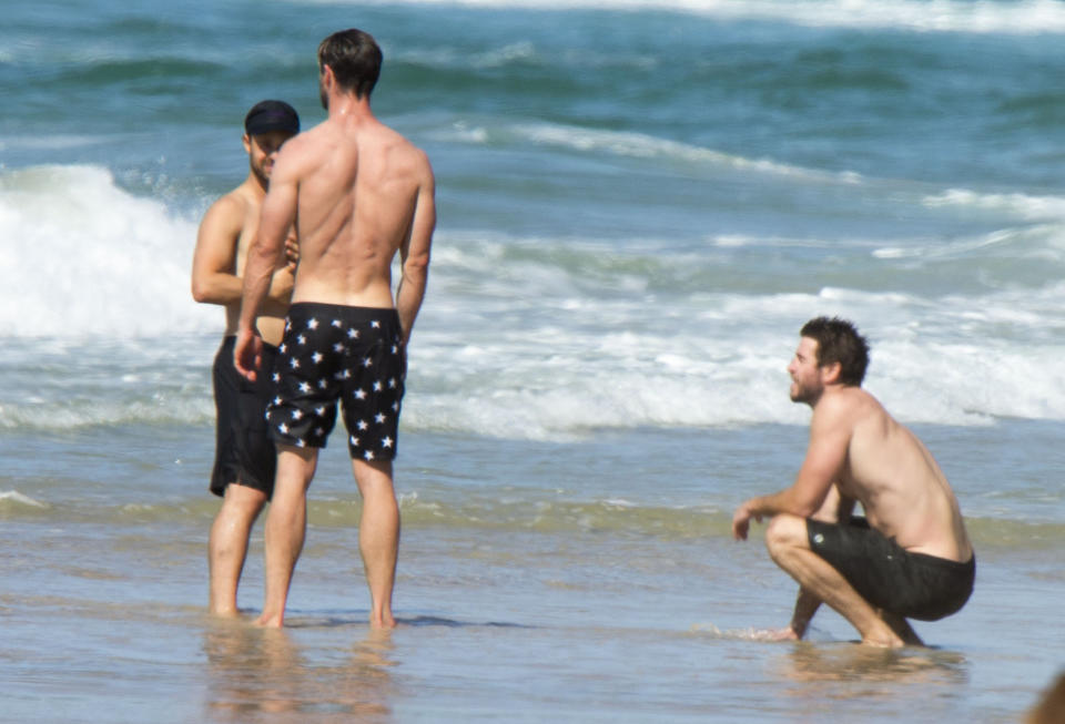 Liam crouched by the shore as his brother and friends chatted away. Photo: Media Mode