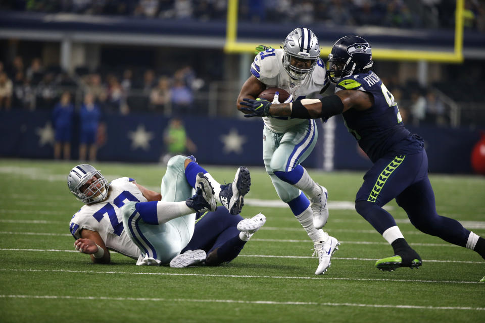 Dallas' Ezekiel Elliott (21) is one of the NFL's most violent runners. Will the new helmet rule strike him at the wrong time? (AP) 