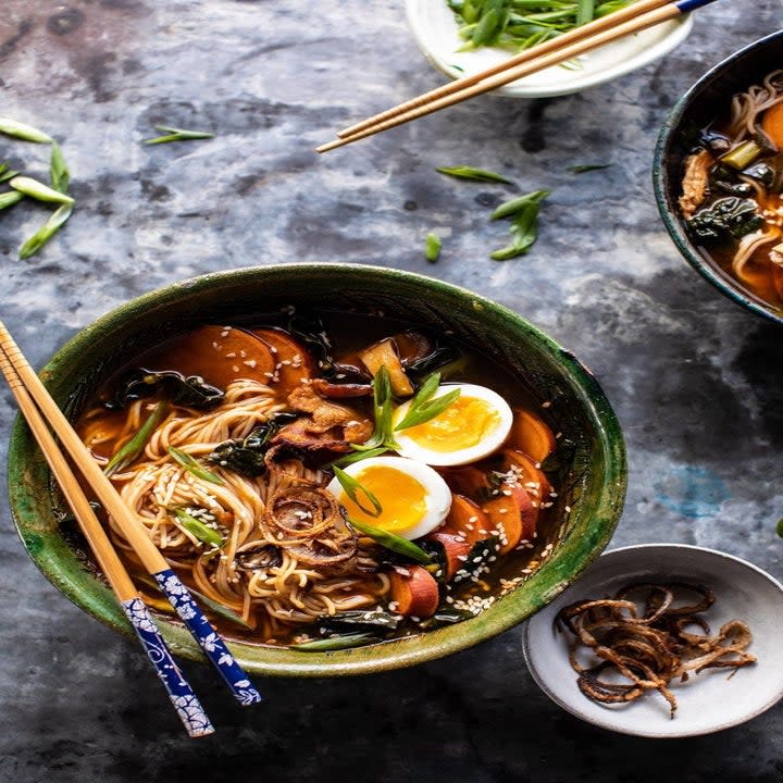 Ramen bowls with fried shallots, sweet potatoes, bacon, and eggs.