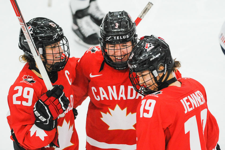 Olympics: (L-R) Marie-Philip Poulin #29, Jocelyne Larocque #3 and Brianne Jenner #19 of Canada celebrate after their teammate Jamie Rattray #47 , scored against United Sates in the 2021 IIHF Women's World Championship gold medal game played at WinSport Arena on August 31, 2021 in Calgary, Canada. (Photo by Derek Leung/Getty Images)