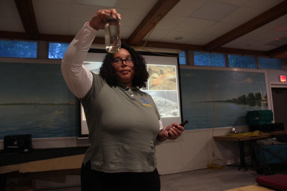 Christina Carter of the Great Lakes Fishery Commission displays a preserved juvenile sea lamprey during a June 2023 presentation to Salmon Unlimited of Wisconsin in Racine.