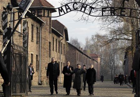 U.N. Secretary General Ban Ki-moon and his wife Yoo Soon-taek (R) walk with holocaust survivor and Council for the Museum of the History of Polish Jews chairman Marian Turski(2nd R) and museum director Piotr Cywinski (L) during a visit to the Auschwitz-Birkenau memorial and former concentration camp November 18, 2013. REUTERS/Kacper Pempel