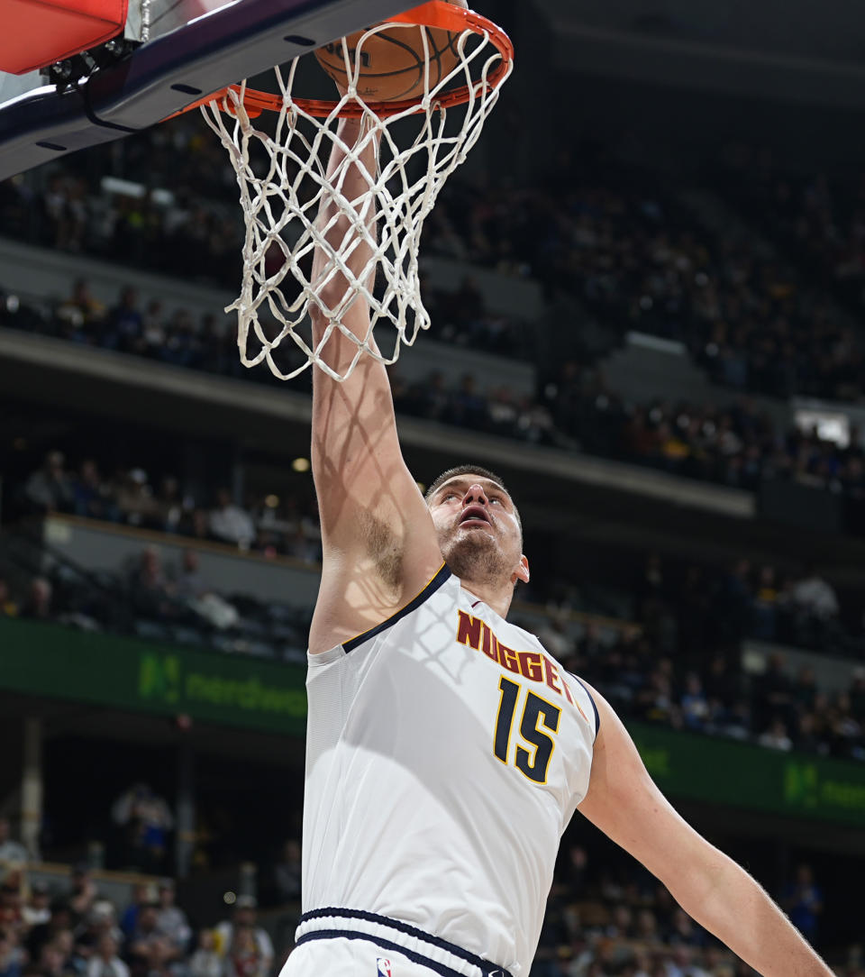 Denver Nuggets center Nikola Jokic scores in the second half of an NBA basketball game against the Portland Trail Blazers, Sunday, Feb. 4, 2024, in Denver. (AP Photo/David Zalubowski)