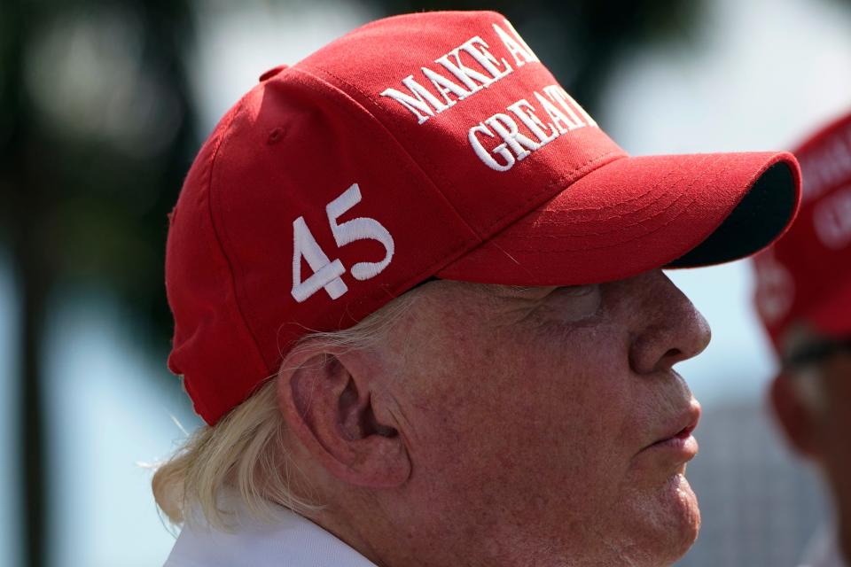 Former President Donald Trump stands on the course during the ProAm of the LIV Golf Team Championship at Trump National Doral Golf Club on Thursday, Oct. 27/