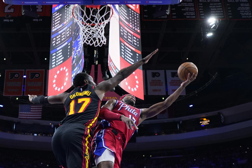 Philadelphia 76ers' Buddy Hield, right, goes up for a shot against Atlanta Hawks' Onyeka Okongwu during the first half of an NBA basketball game, Friday, Feb. 9, 2024, in Philadelphia. (AP Photo/Matt Slocum)