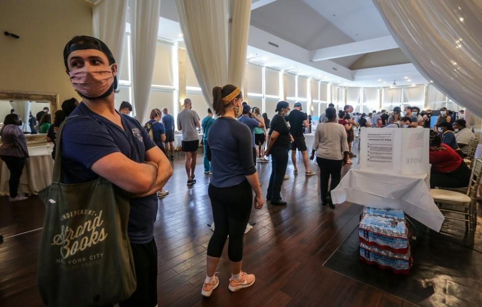 In this a June 9, 2020, file photo, voters wait in line to cast their ballots in the state’s primary election at a polling place in Atlanta, Ga. (AP Photo/Ron Harris, File)