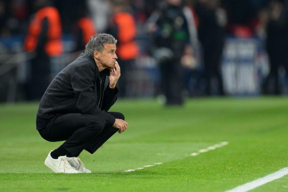 Luis Enrique crouches down in his technical area